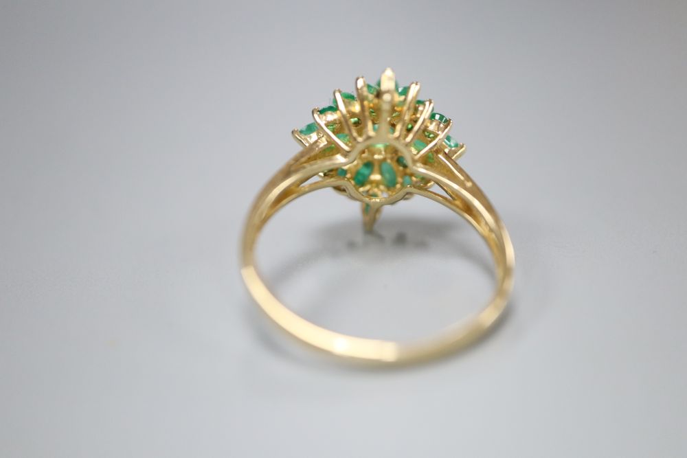 A modern 9ct gold and emerald cluster ring, size R, gross 3.4 grams.